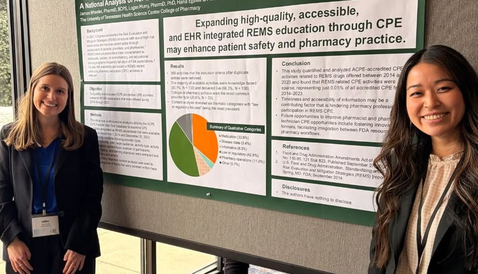 Miller Hadley and Hana Egawa std in front of their research poster.