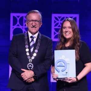 Amanda Cavness recieves award on stage.
